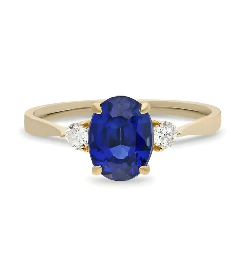 Cadaqués yellow gold engagement ring with an oval sapphire and two diamonds