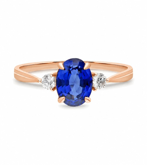 Rose gold engagement ring with an oval sapphire and two diamonds | Staring